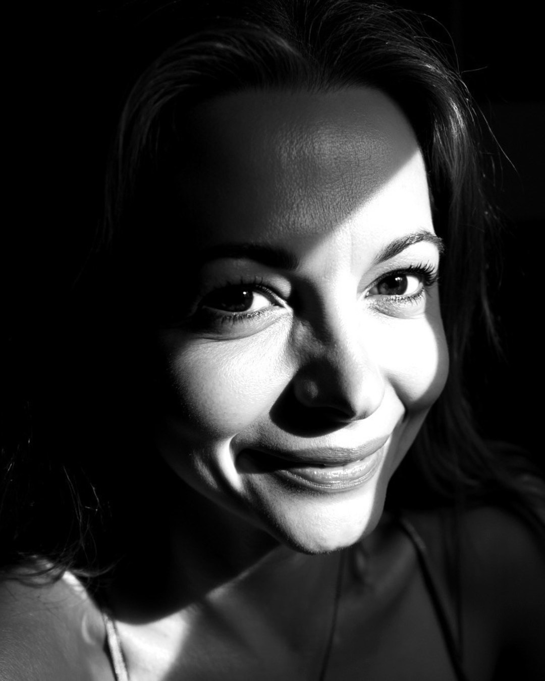 Annie Ferro, half her face in daylight, half in shadow.